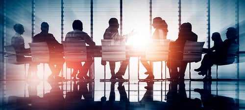 Business people gathering around a table