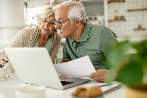 Older married couple reviewing finances